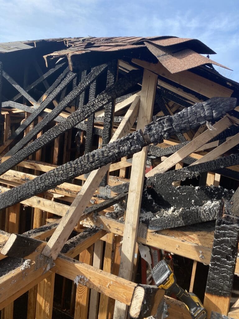 Charred wooden roof support beams from a house fire. Charred wooden roof support beams from a house fire.